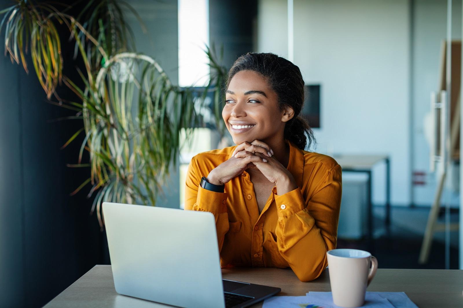 A young woman smiles at the possibility of consolidating her debt with a consumer loan.